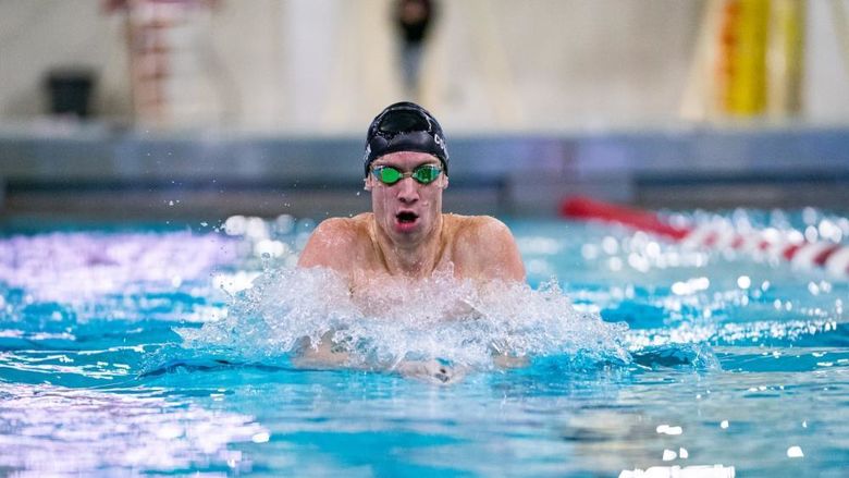 Penn State Behrend swimmer Tim Compton competes in a breaststroke race.