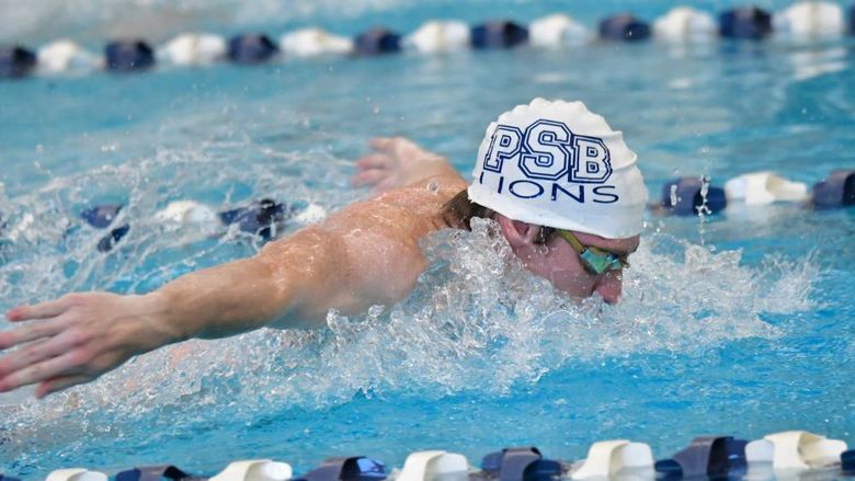 A Penn State Behrend swimmer competes in a butterfly event.