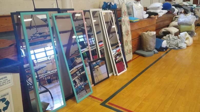 Stacked mirrors and other housewares at the Penn State Behrend Trash 2 Treasure sale.