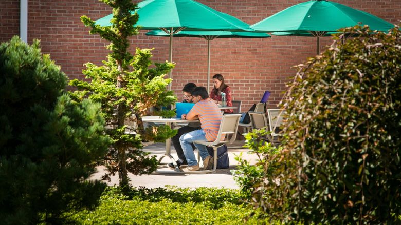 Students work on a patio outside Penn State Behrend's Kochel Center