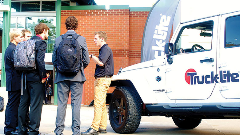 A Truck-Lite recruiter talks with students at a Penn State Behrend career fair.