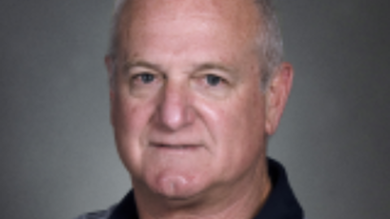 Photo of man in front of gray background