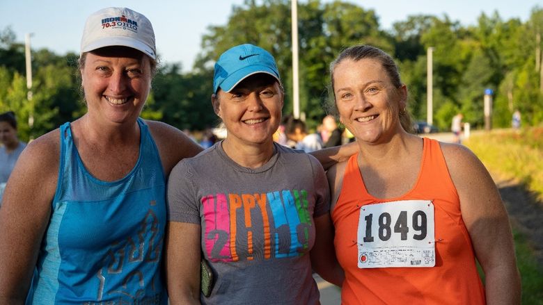 Three women pose at the finish line after the Women's Engagement Council's Run for Women at Penn State Behrend.