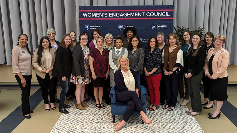 large group of women posing with guest speaker, Ashleigh Walters.