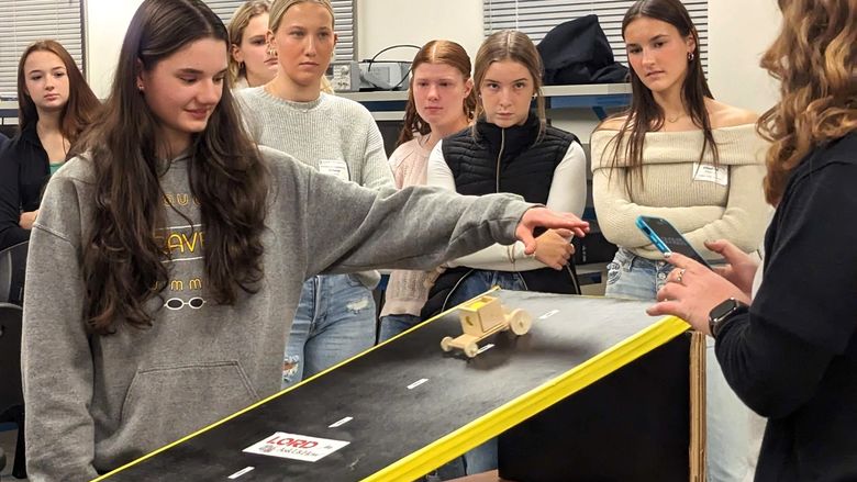 High-school girls test a model car during an engineering program at Penn State Behrend.