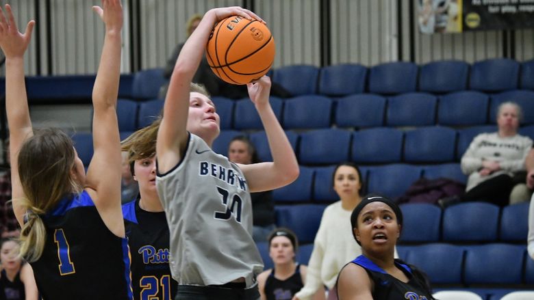 A member of the Penn State Behrend women's basketball team shoots the ball.