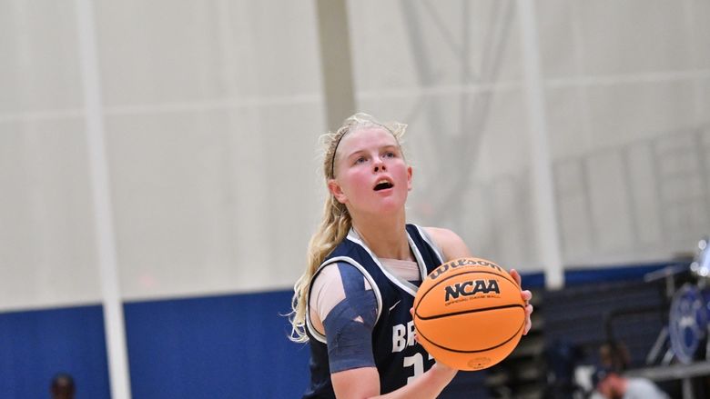 A member of the Penn State Behrend basketball team prepares to shoot the ball.
