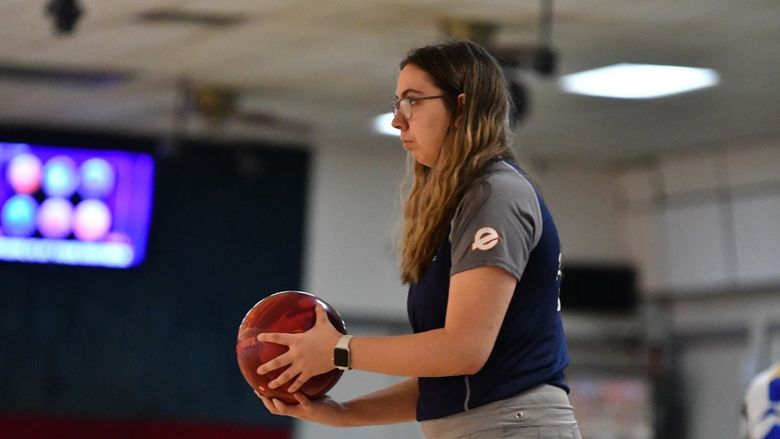A member of the Penn State Behrend women's bowling team prepares to roll the ball.