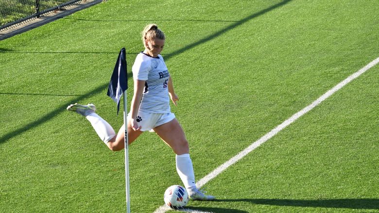 A Penn State Behrend women's soccer player prepares to kick a corner kick.