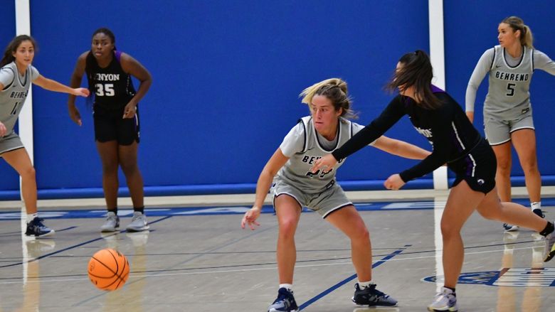A Penn State Behrend basketball player scrambles for the ball.