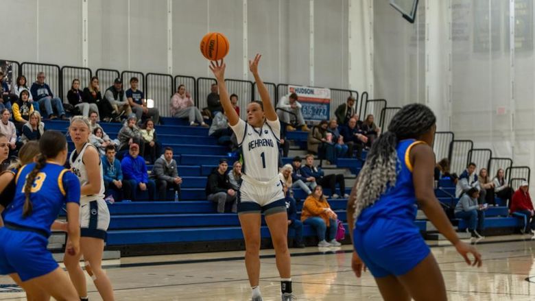 A member of the Penn State Behrend women's basketball team shoots a jump shot.