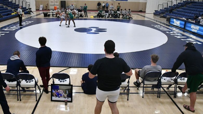 Two wrestlers grapple during a match at Penn State Behrend