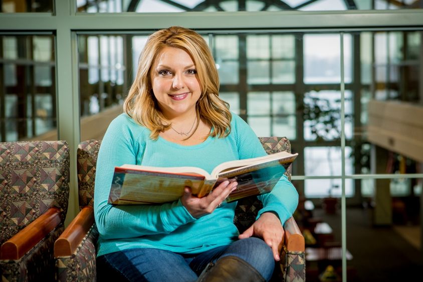 A Penn State Behrend student reads a book in Lilley Library.