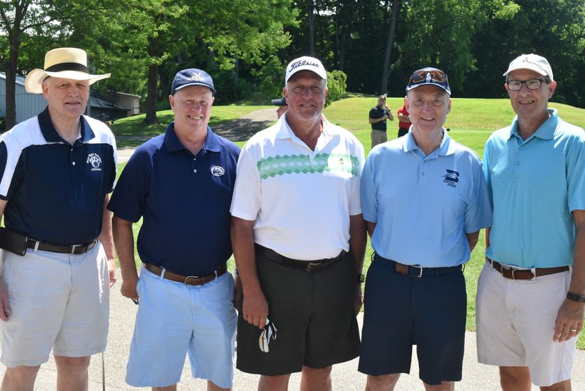 Members of the 1968-69 Penn State Behrend men's basketball team Duane May (far left), Eric Obert, Doug Zimmerman, Roger Sweeting (coach) and Dan Fry pose for a photo during the Herb Lauffer Memorial Golf Tournament.