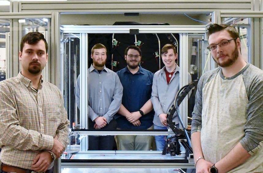 John Nowakowski, far left, Ryan Hutchinson, Michael Gibilterra, Elijah Thompson and Mike Paul worked together to build a large-format 3D printer from scratch in Penn State Behrend's Innovation Commons.
