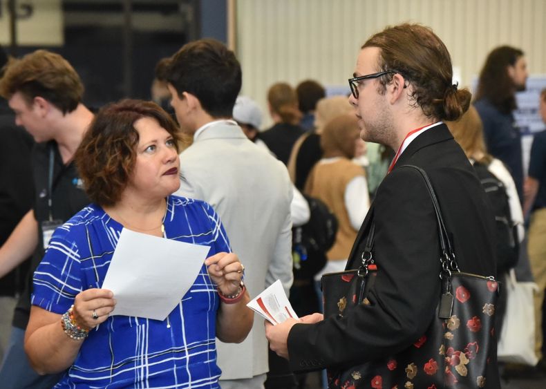 A recruiter talks to a student at Penn State Behrend's fall Career and Internship Fair.