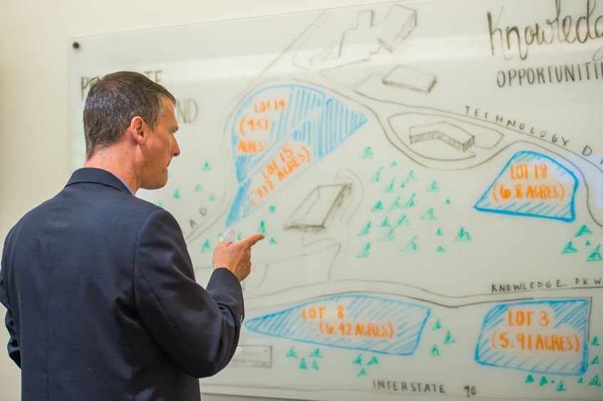 A visitor looks at a map of Penn State Behrend's Knowledge Park