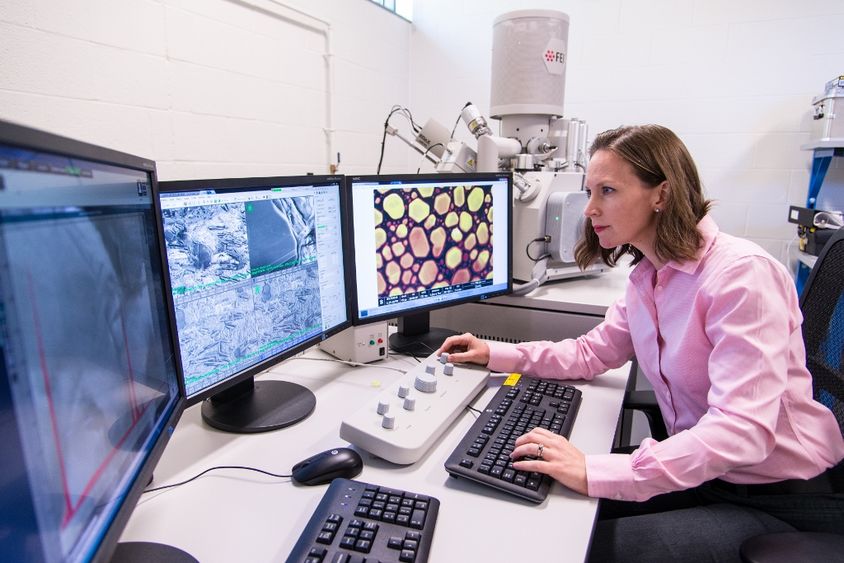 Penn State Behrend assistant professor Alicyn Rhoades works on the colleges environmental scanning electron microscope.