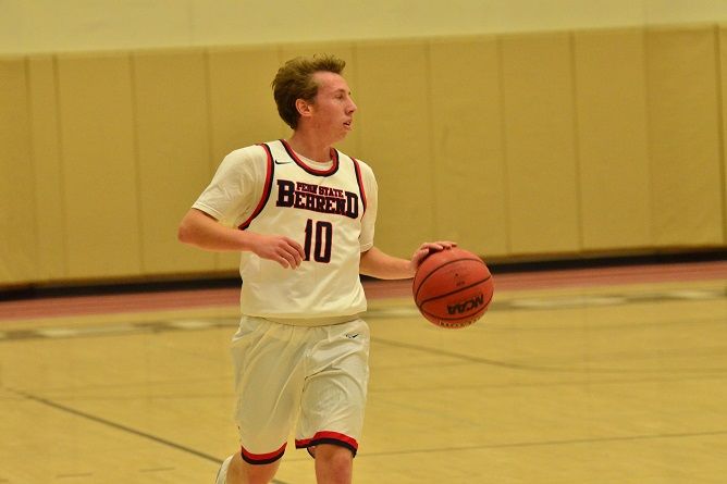 Penn State Behrend basketball player Andy Niland dribbles the ball.