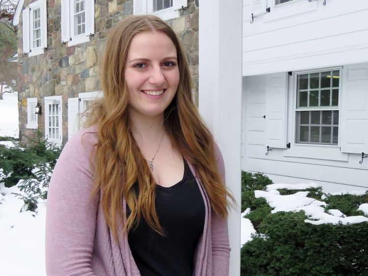 Penn State Behrend student Ashley Price stands outside Glenhill Farmhouse