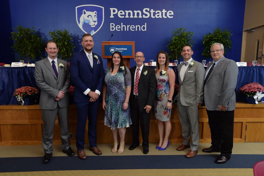 Six new members of the Penn State Behrend Athletics Hall of Fame pose with Director of Athletics Brian Streeter.