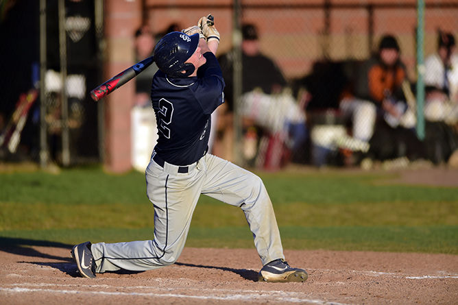 A Penn State Behrend baseball player hits the ball.