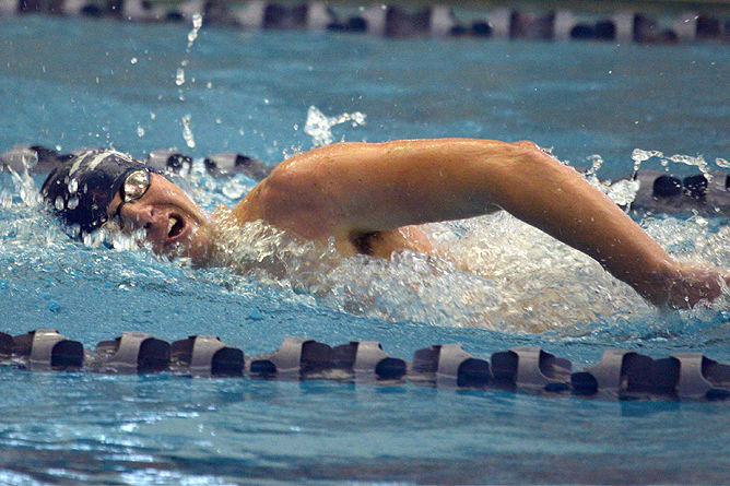 A Penn State Behrend swimmer competes in a freestyle race.