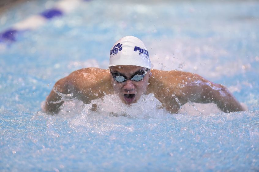 A Penn State Behrend swimmer competes in the butterfly event.