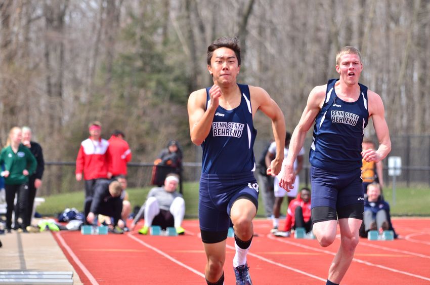 Penn State Behrend runners race on an outdoor track.