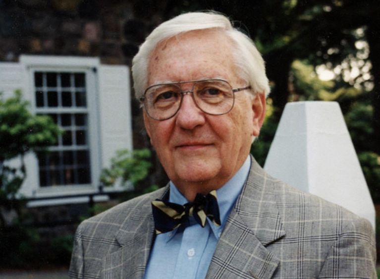 Former Penn State Behrend administrator Ben Lane stands in front of the college's Glenhill Farmhouse.