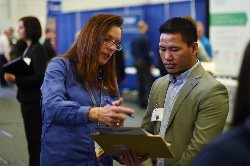 Bikash Subba, a senior mechanical engineering technology major, converses with an employer at Penn State Behrend's spring Career and Internship Fair, held March 16 at the college.