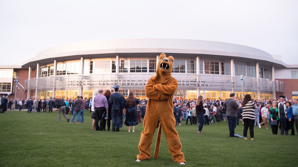 The Nittany Lion mascot poses outside a Penn State Behrend commencement ceremony.