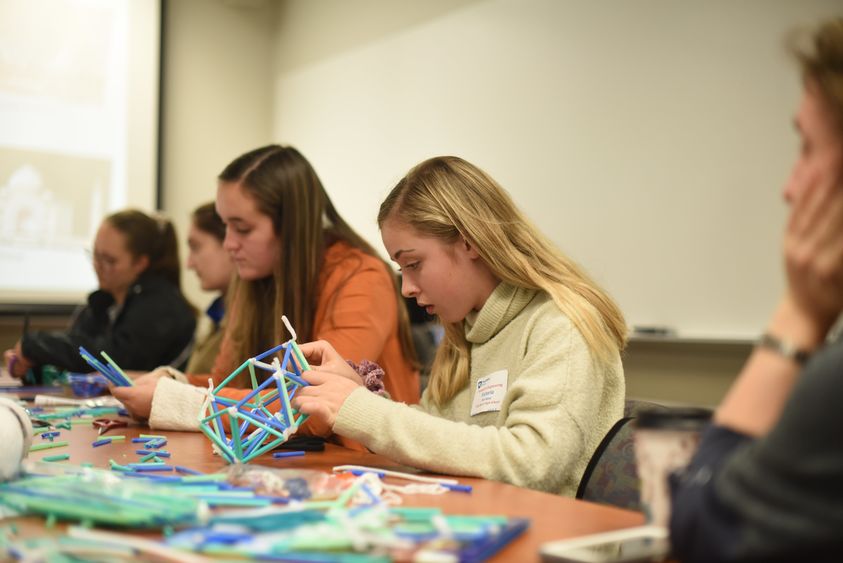 Victoria Purchase works to create a dome during Women in Engineering Day at Penn State Behrend.
