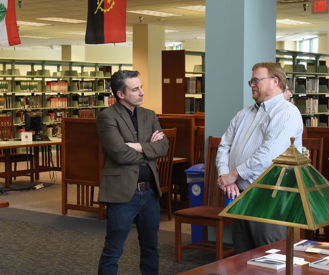 Associate professor of philosophy Joshua Shaw, at left, and associate librarian Russ Hall converse during the Faculty Publication Reception at Penn State Behrend.
