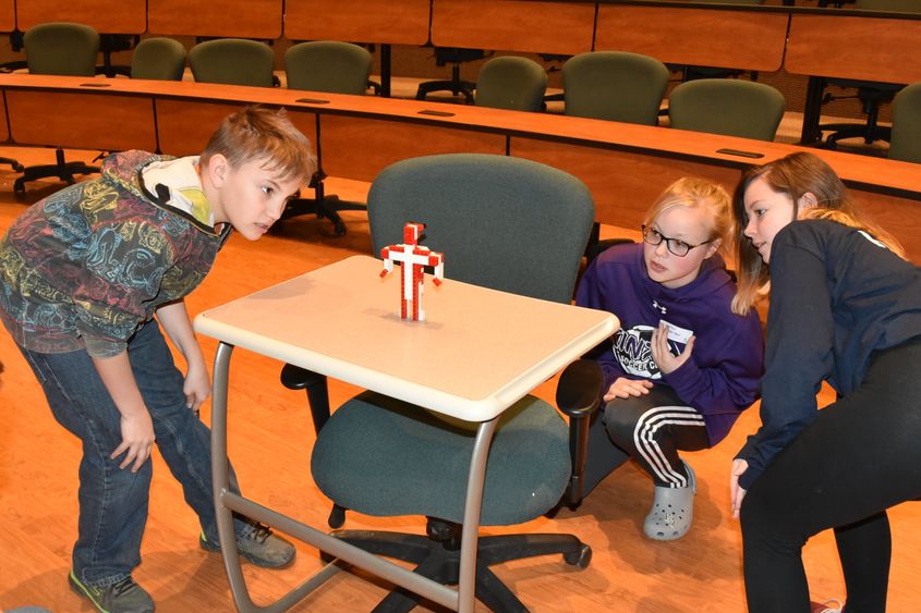 Beaty-Warren Middle School seventh-grade student Kole Howard, left, observes a LEGO robot during the “LEGO Person” activity at 21st Century Kids, held Friday, April 20, at Penn State Behrend. 