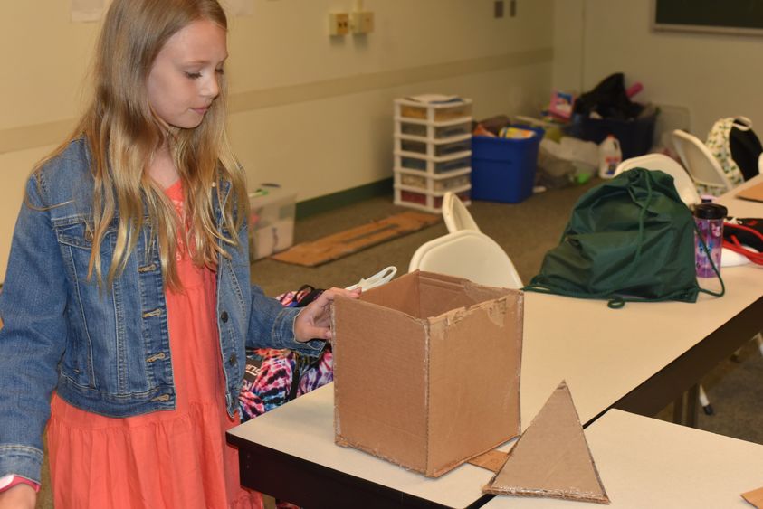 Linnea Henderson works to construct a dream home during the "Engineer and Build Your Dream Home" class at Penn State Behrend's College for Kids. 