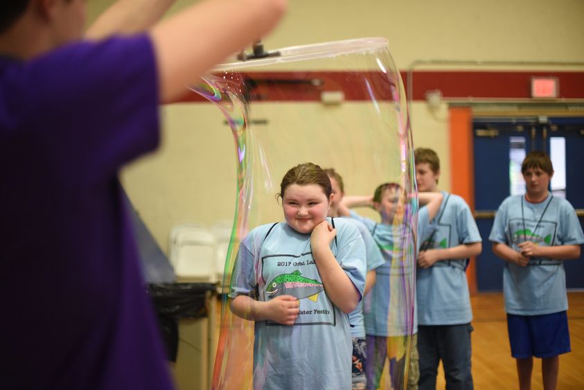 A fifth-grade student enters a life-size bubble.