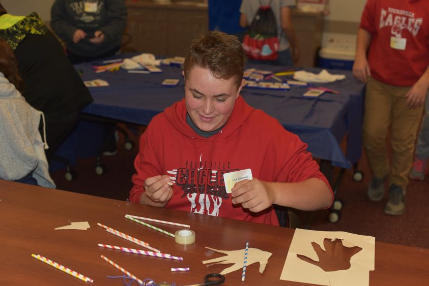 Lex Leamon works to create a mechanical hand during 21st Century Kids, held Friday, Oct. 19, at Penn State Behrend. 