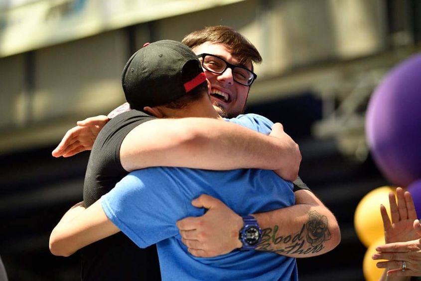Penn State Behrend senior Billy Santoro hugs a boy to whom he has donated bone marrow.