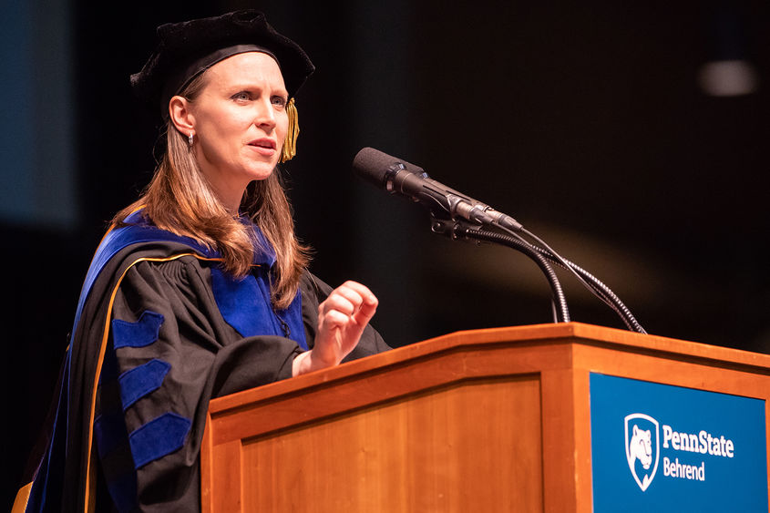 Dr. Alicyn Rhoades at commencement podium