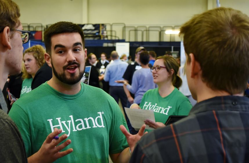 Tyler Conn, a Developer 2 for Hyland, meets with students at Penn State Behrend's Fall Career and Internship Fair.