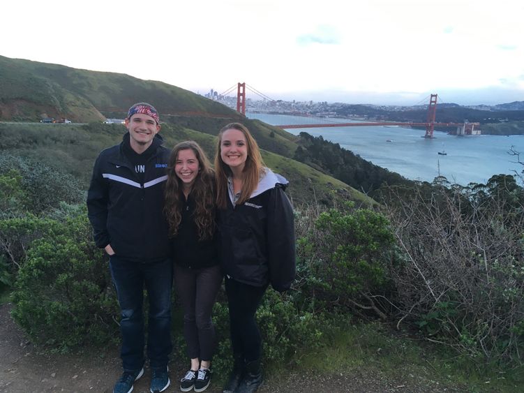 Helen Mendenhall, center, stands with Patrick Kress, left, and Alex Laffey during Penn State Behrend's Alternative Spring Break (ASB) trip to Oakland last semester. 