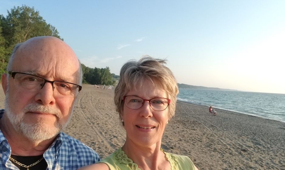 A selfie of James and Sandra Schlaudecker on a beach