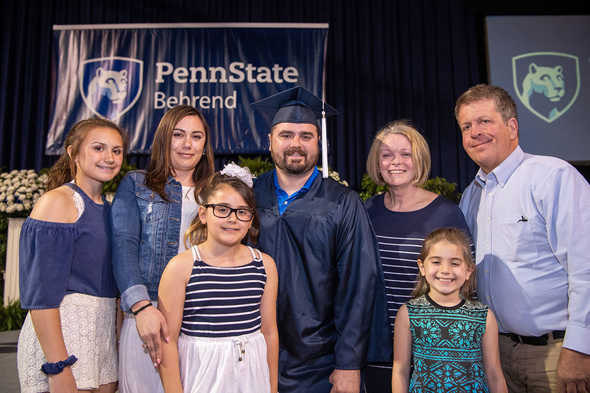Adult graduate and family at commencement