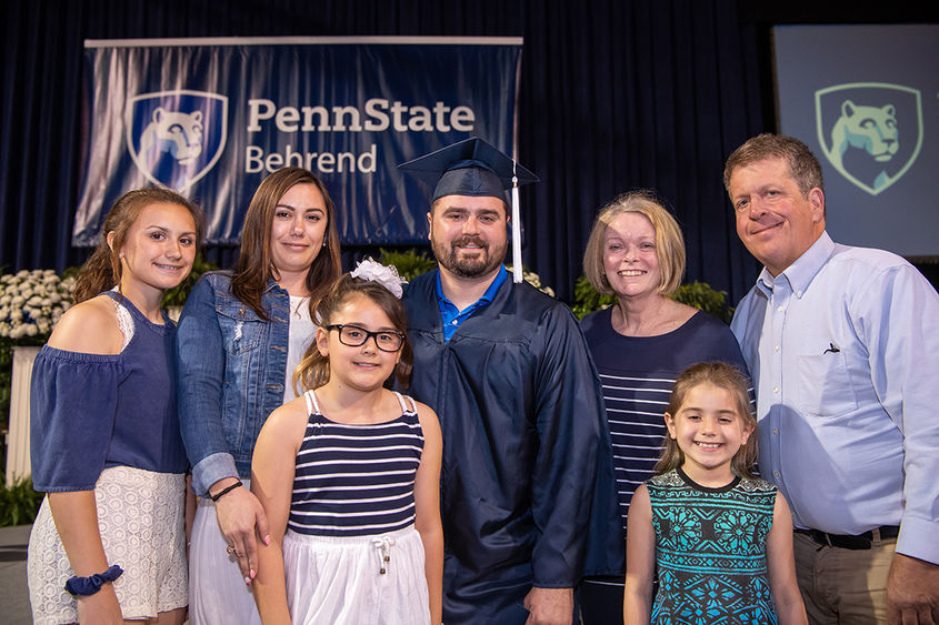 Adult graduate and family at commencement Adult graduate and family at commencement