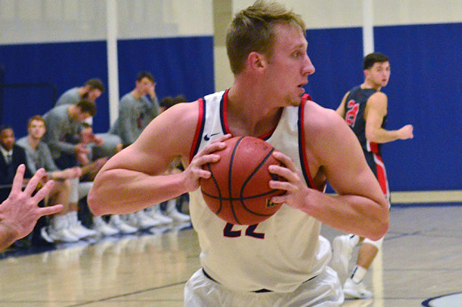 Penn State Behrend basketball player Justin Gorny prepares to pass the ball.