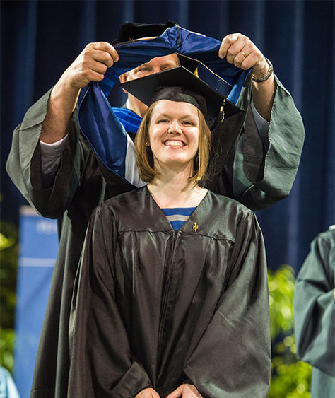 MBA in Pittsburgh graduate receiving her hood