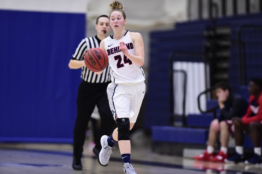 Penn State Behrend basketball player Kourtney Beamesdefer dribbles the ball.