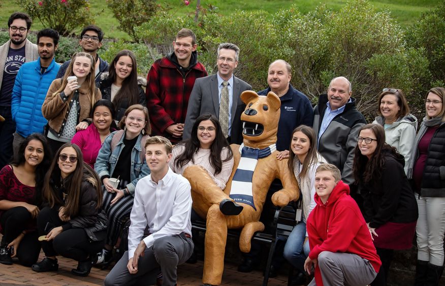 Students, faculty and staff pose at Penn State Behrend's new Nittany Lion bench.