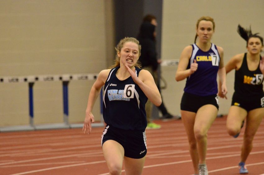 A Penn State Behrend runner competes in an indoor race.